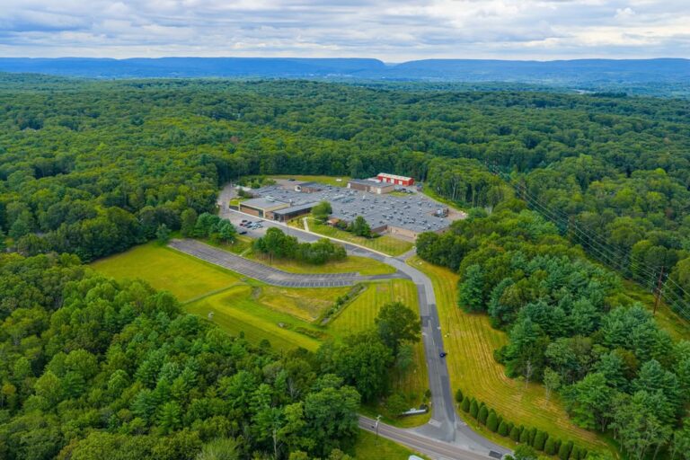 Aerial view of the Monroe Career & Technical Institute campus surrounded by forest