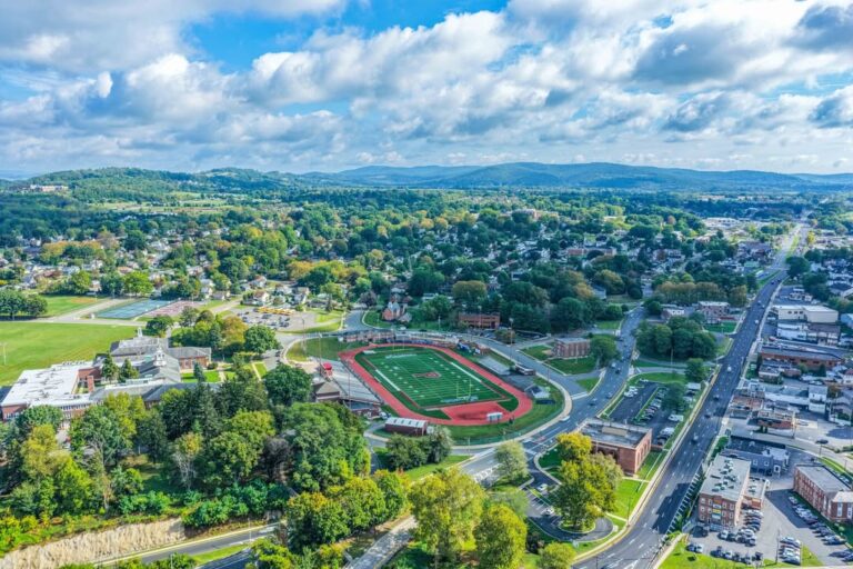 Aerial view of a town with an athletic field and running track