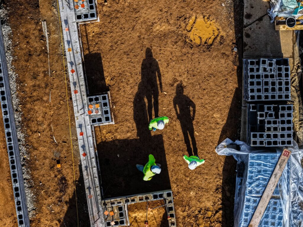 Aerial view of a crew laying block foundation walls
