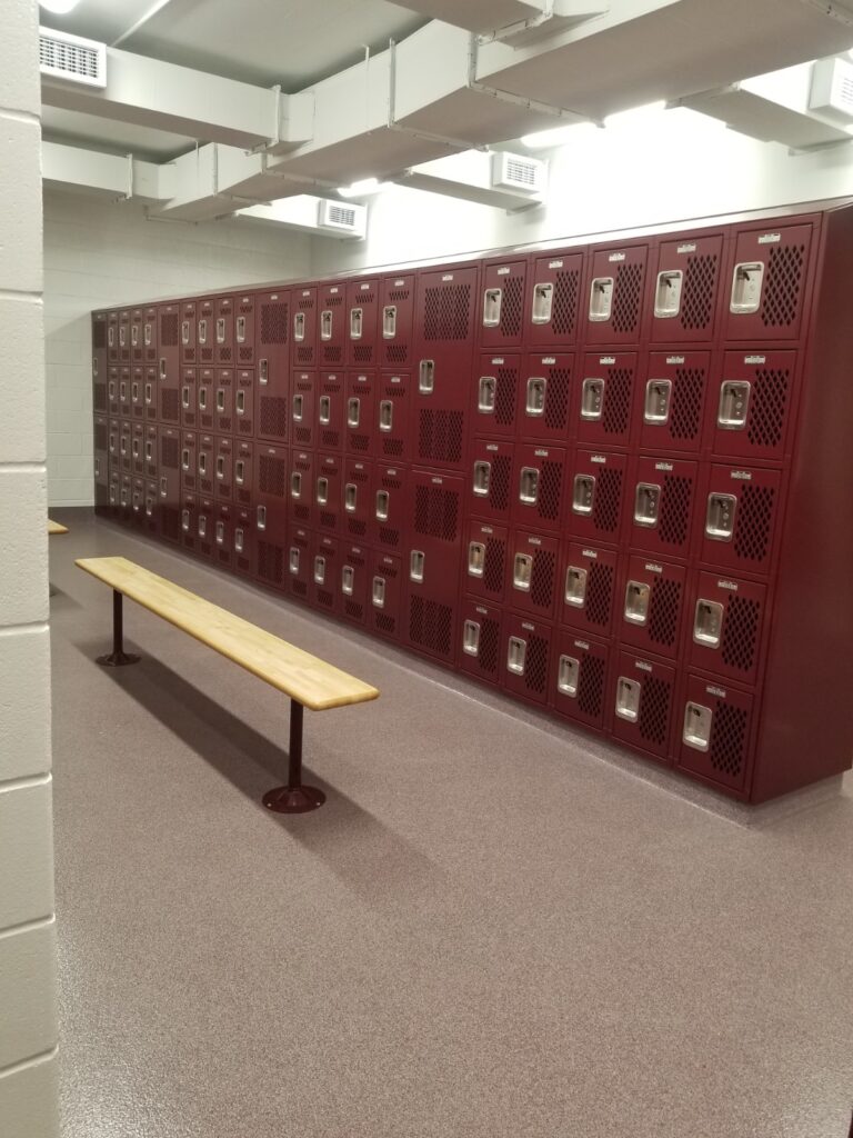 School locker room with maroon lockers and benches