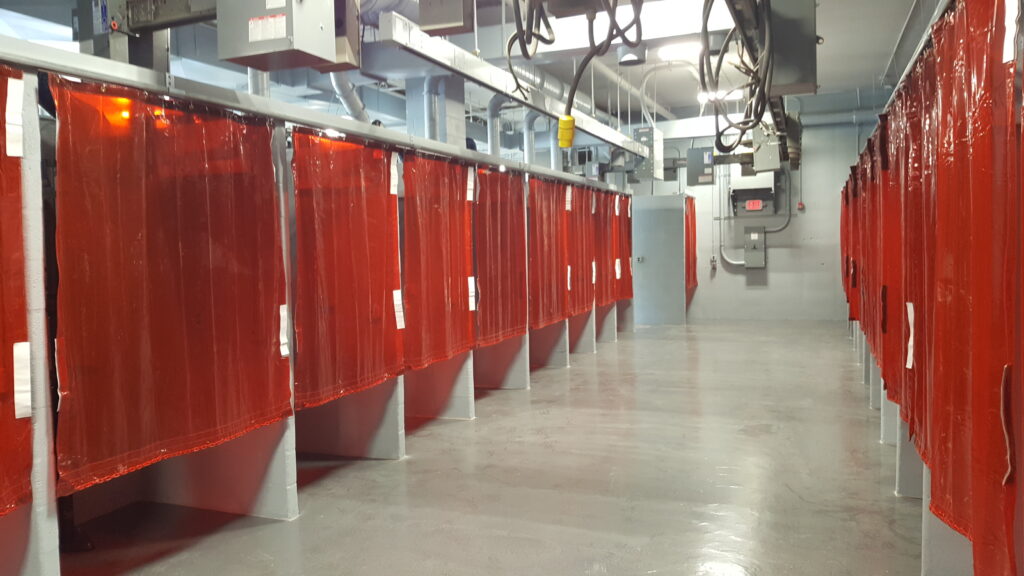 School locker area with red curtained changing stalls