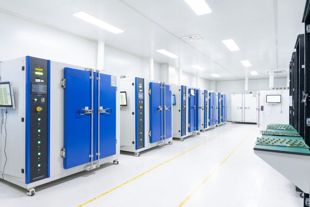 Brightly lit technical facility with rows of equipment cabinets