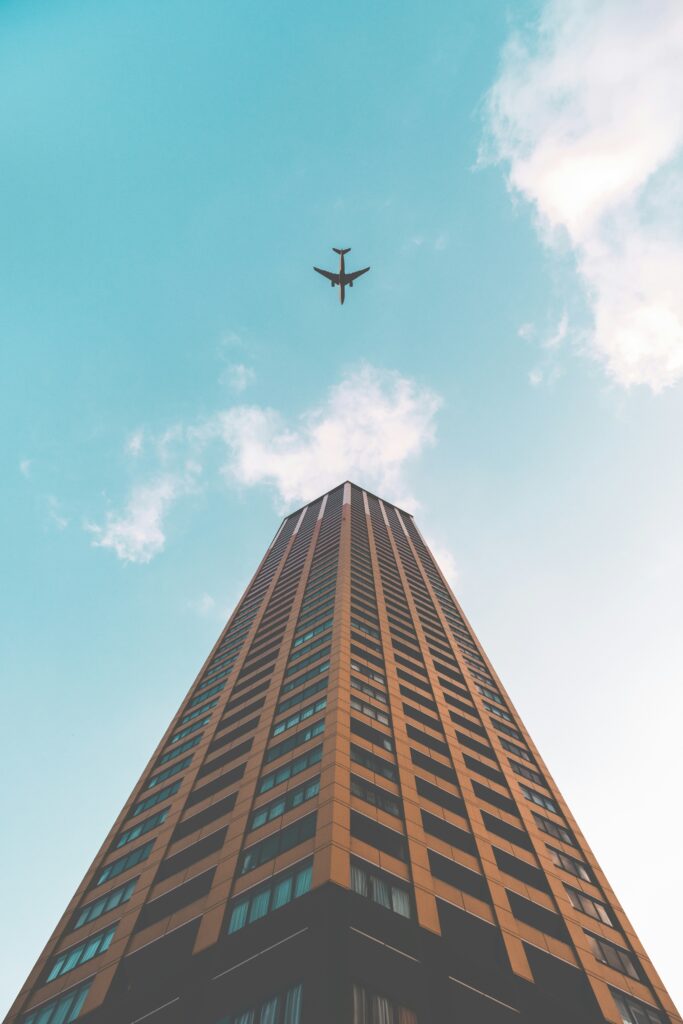 Looking up at a high-rise tower against a blue sky